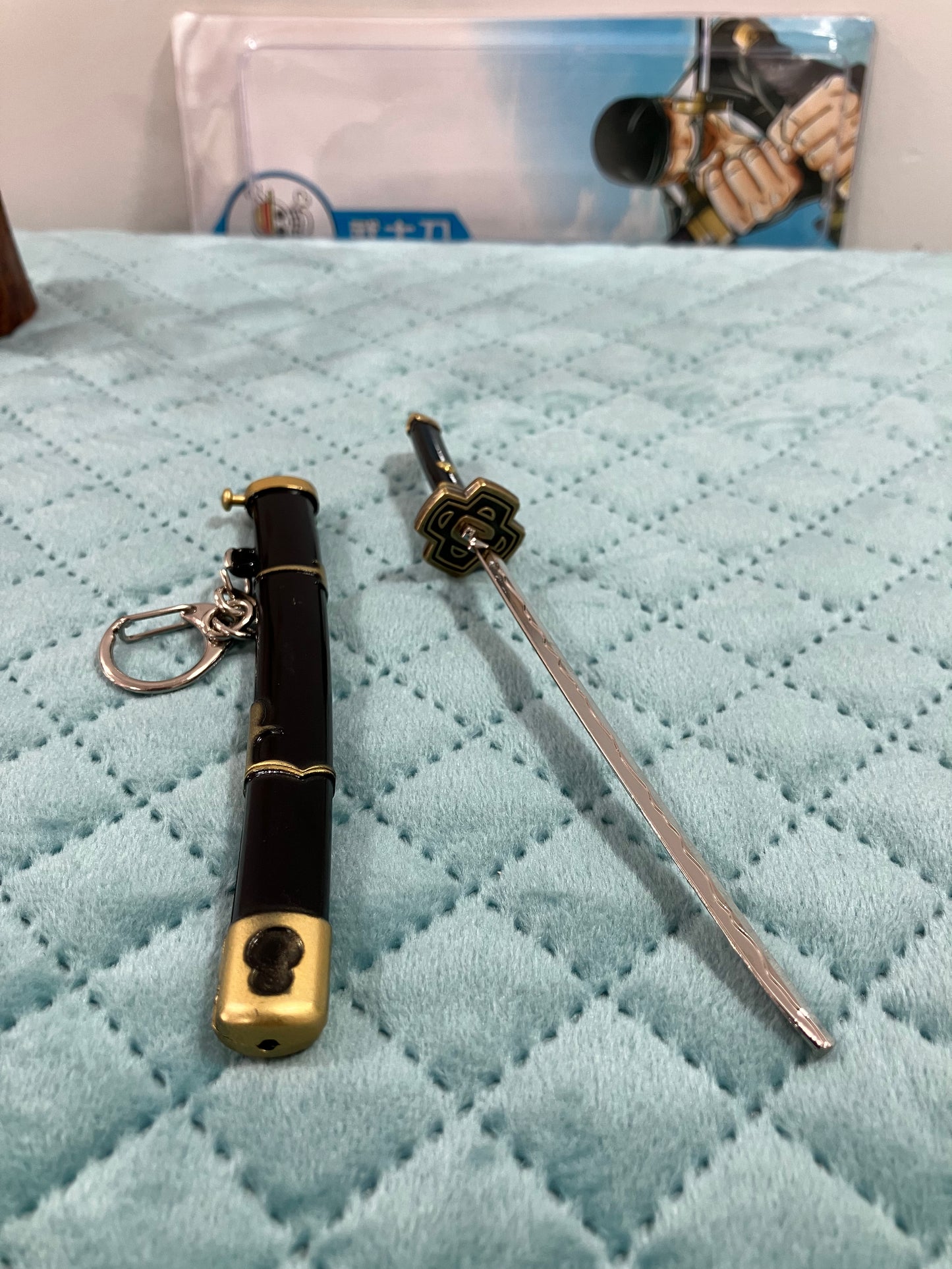 Metal katana keychains with button lock mechanism